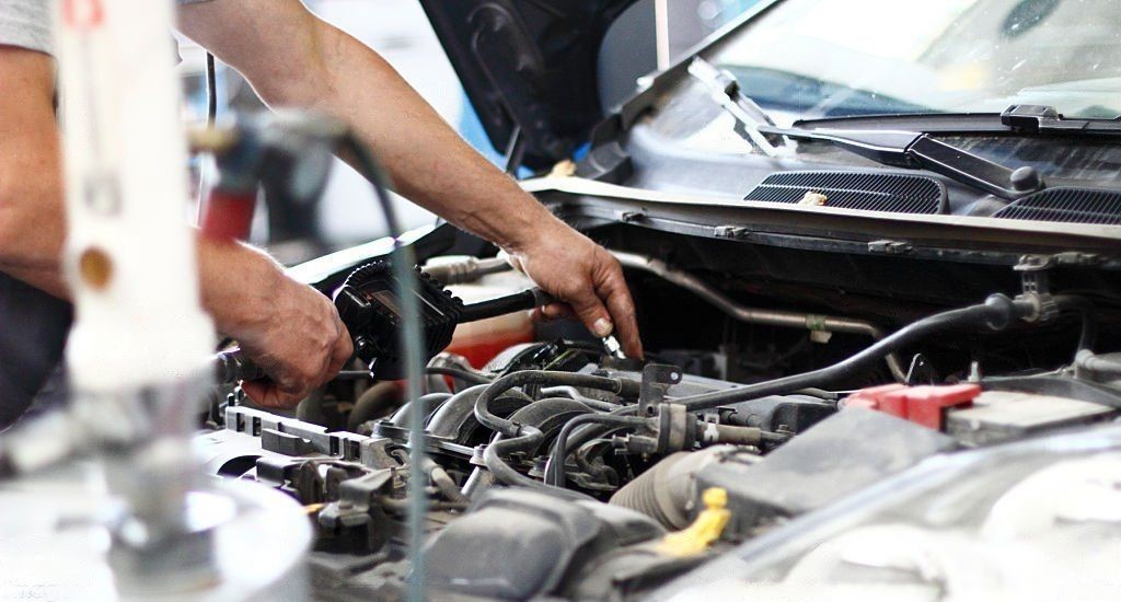 auto mechanic repairing buick car engine