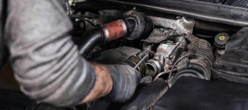 mechanic repairing jeep engine with gloves 