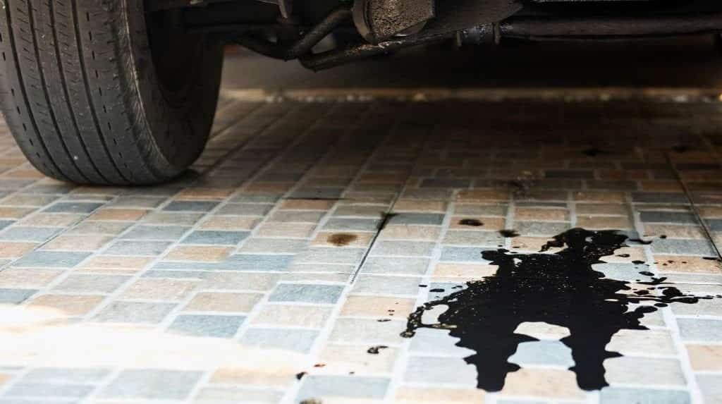 Oil leaks or drops from the car's engine on the parking lot
