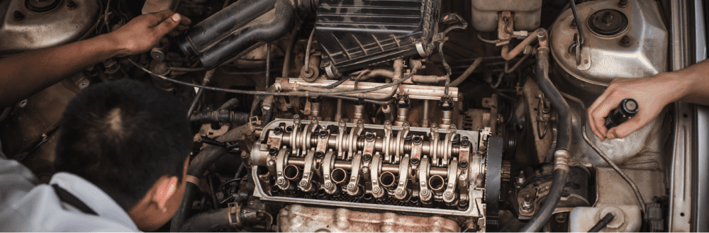 mechanic inspecting car engine 
