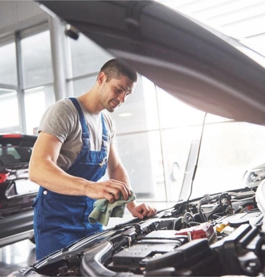 a mechanic cleaning the car engine 